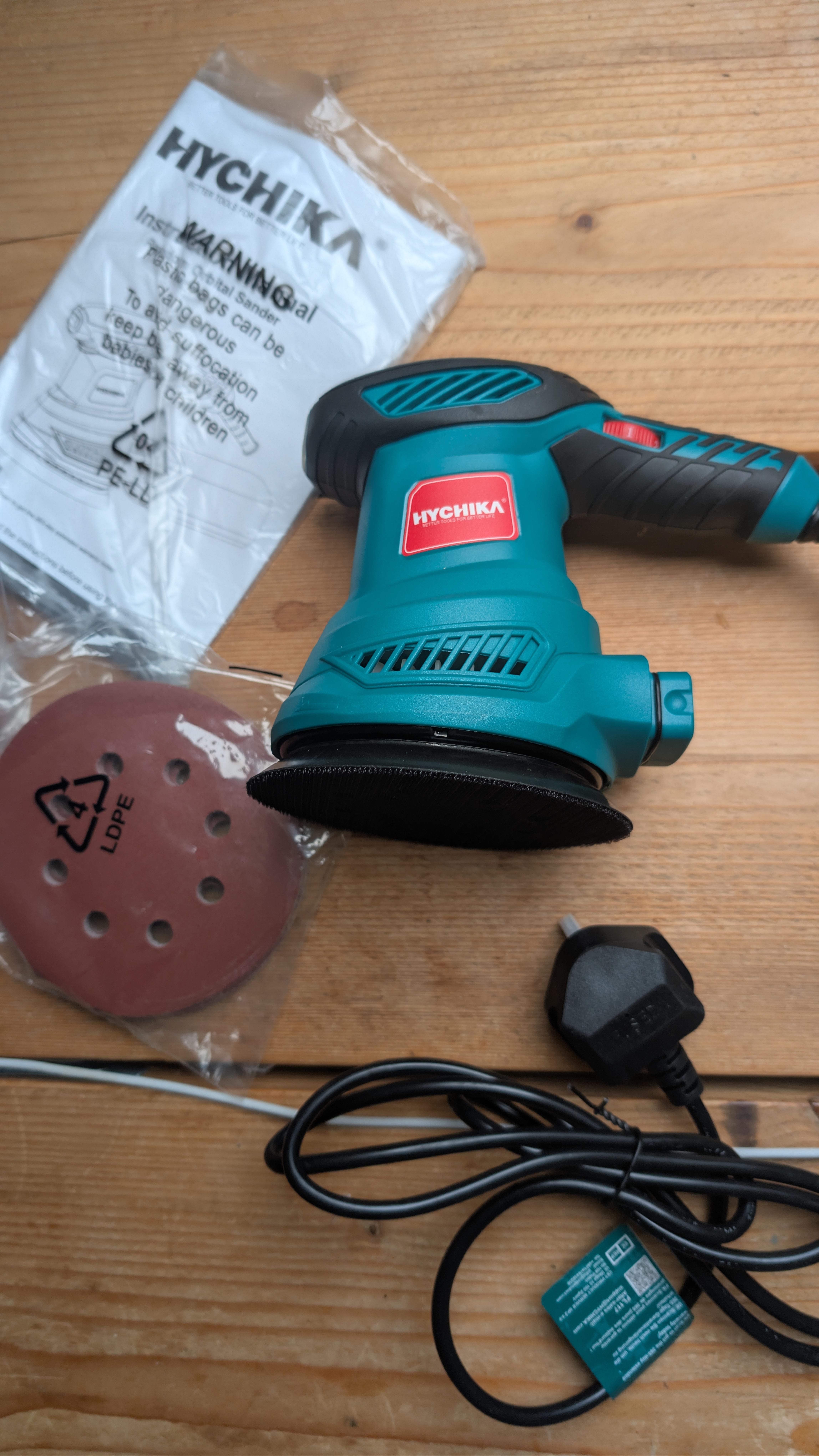 HYCHIKA 300W orbital sander unboxed with sanding discs and dust bag included