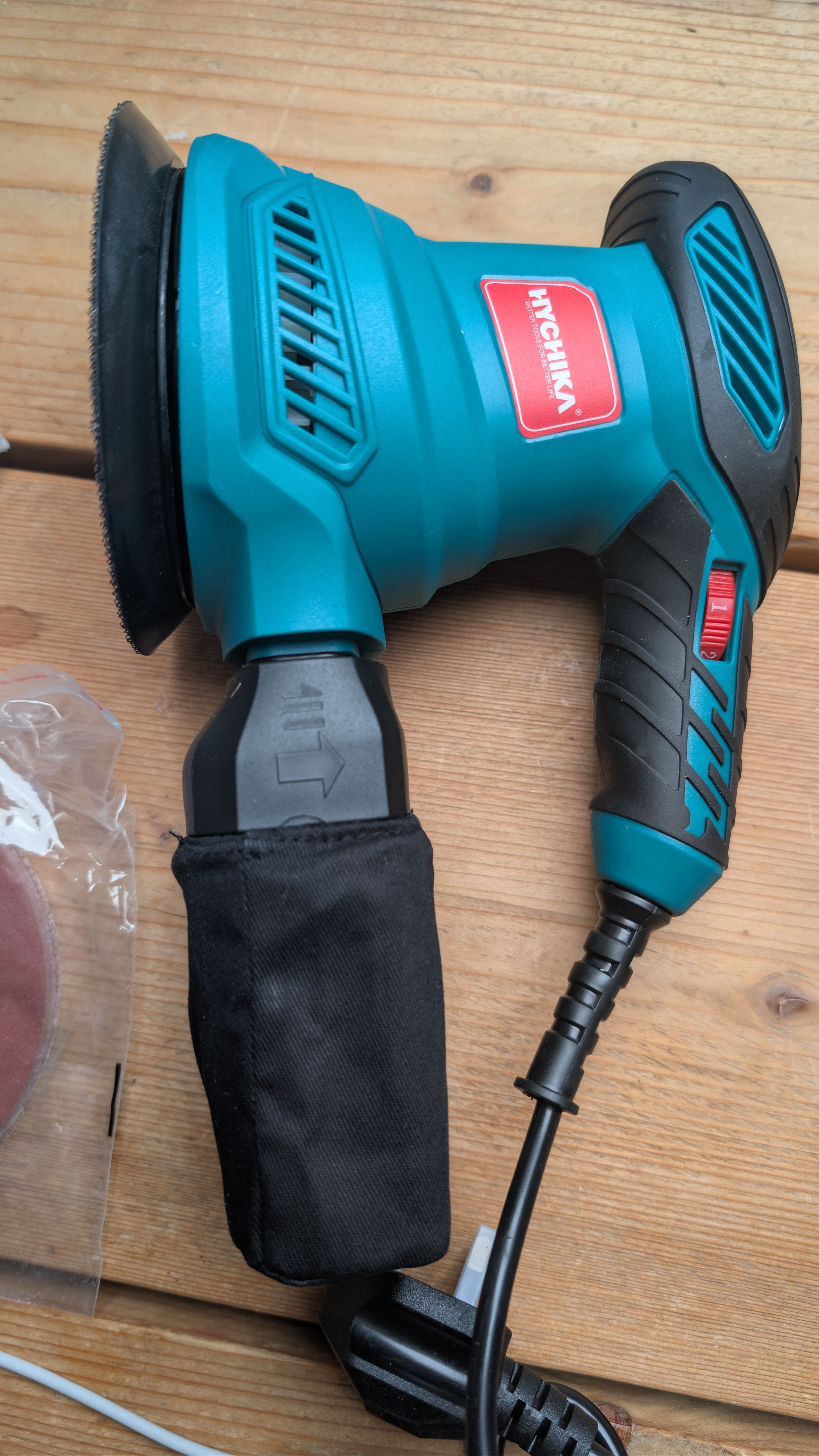 HYCHIKA sander with dust collection bag attached during sanding