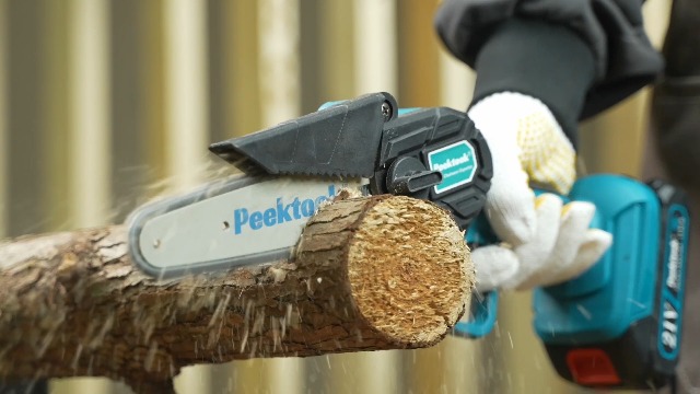 Peektook 6-inch Cordless Mini Chainsaw in action, cutting a small branch